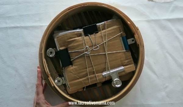 placing the eco print paper bundles inside the bamboo steamer 