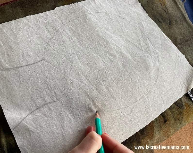 drawing a face on a piece of fabric to start the embroidered portrait