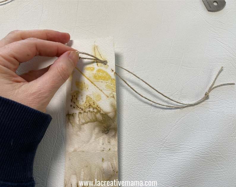 looping the tag through the paper bag 