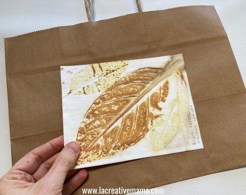 placing the printed card in the middle of the paper bag 