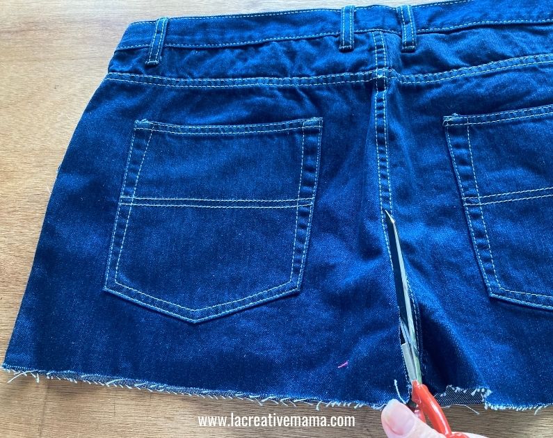 cutting  a pair of jeans 