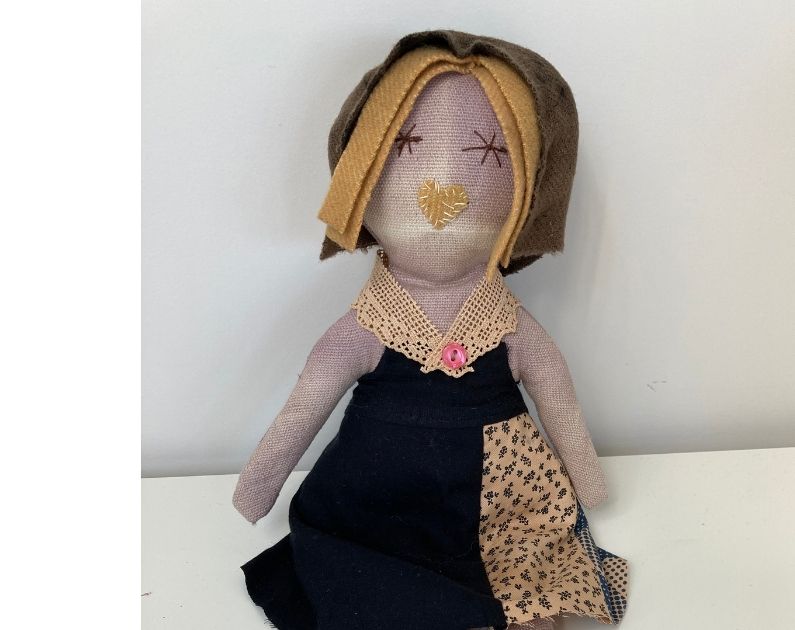 one rag doll dressed in a vintage dress made up from a doillie