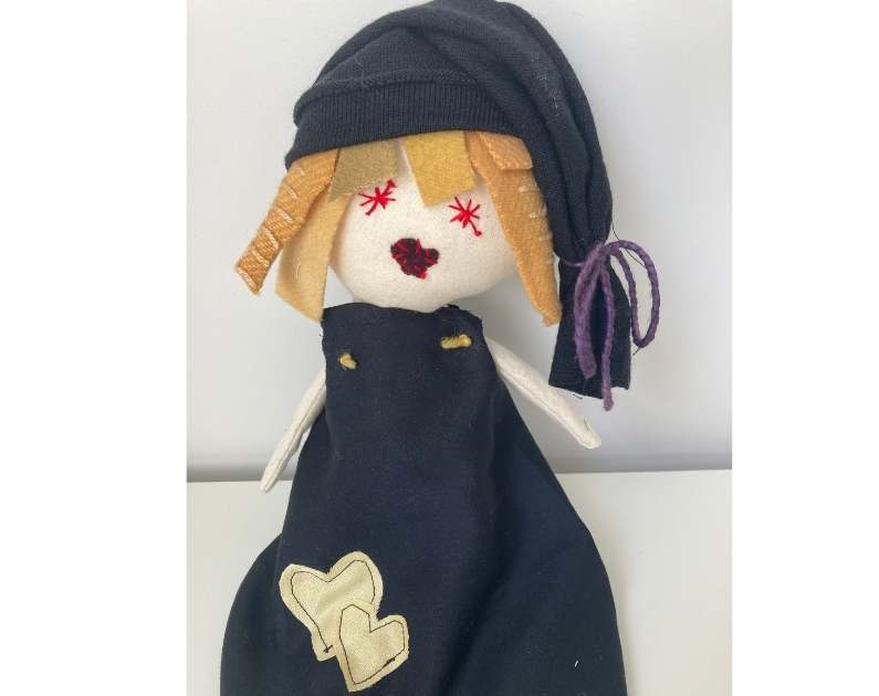 rag doll wearing a  wool hat 