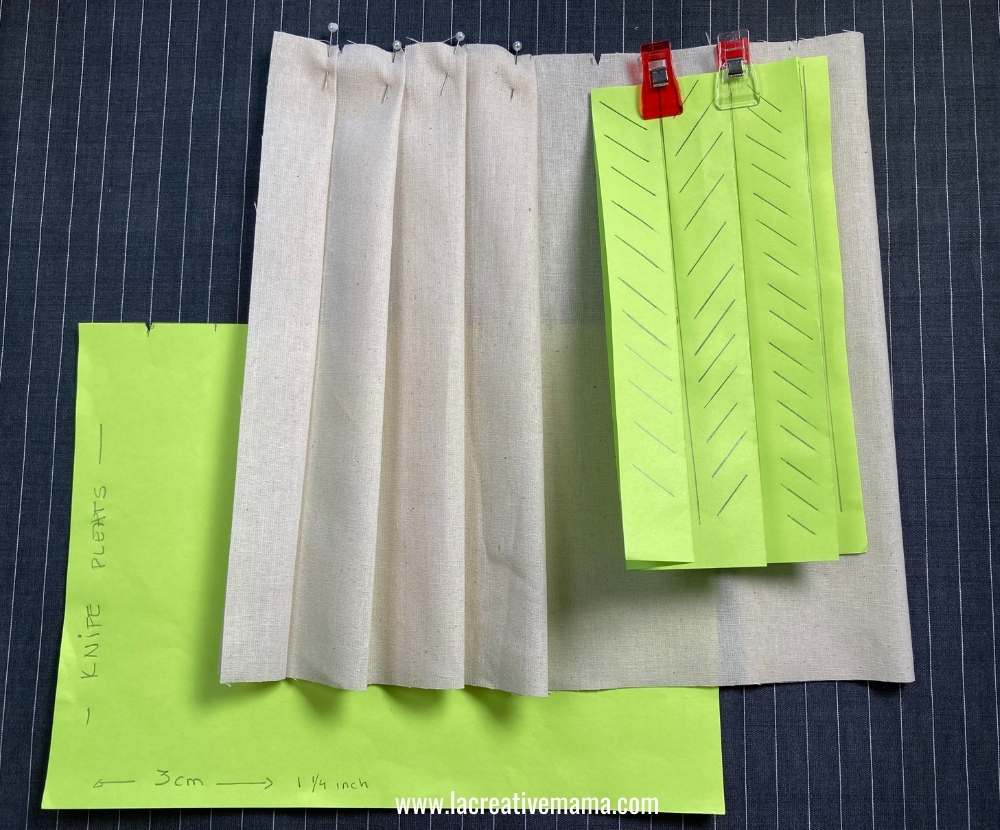 a sample of the fabric pleated and the paper patterns used 