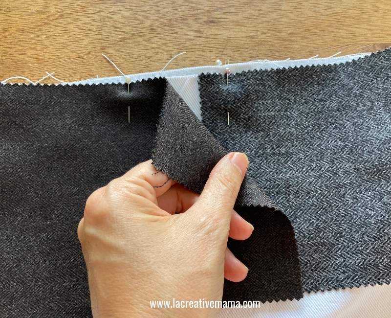 stitching the facing to the bag, leaving an overlap 