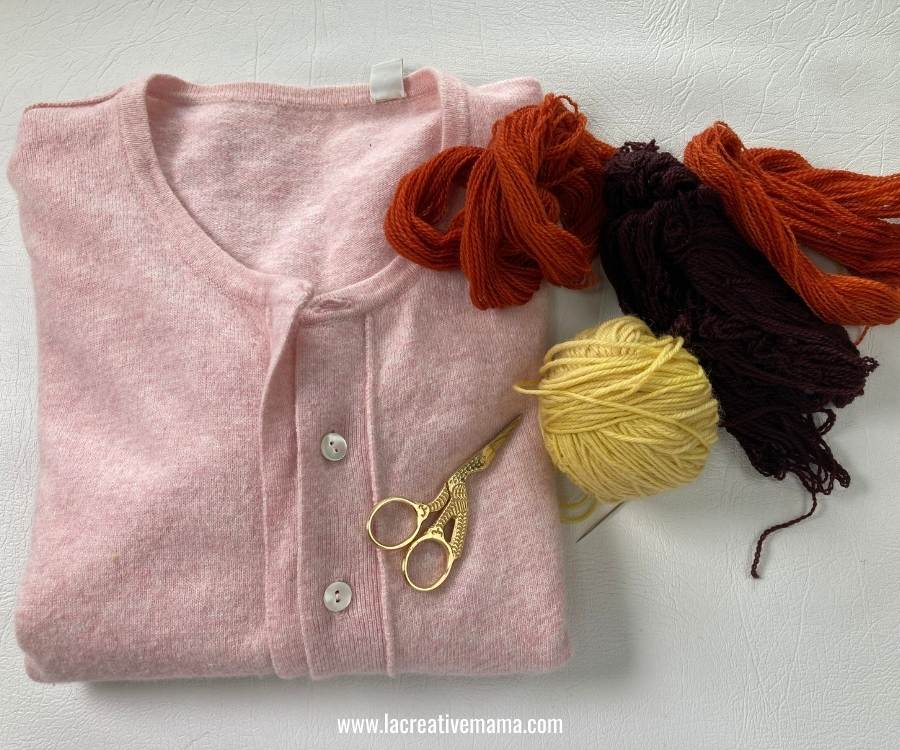 a plain wool cardigan and hand dyed wool yarn ready to be upcycled 