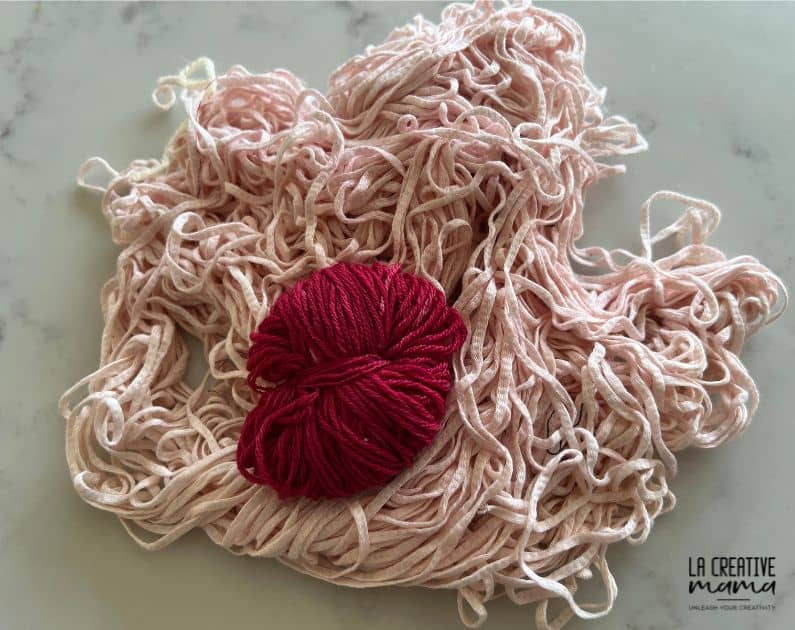 a photo of cotton yarn which was dyed using cochineal dye but came out a very light pink because it was mordanted using the wrong mordant. There is a small pink yarn which was mordanted with the correct mordant for cotton.  