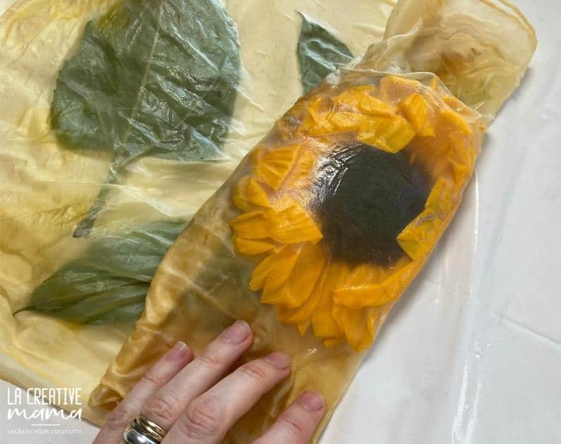 making a tight eco printing bundle using silk and a sunflower