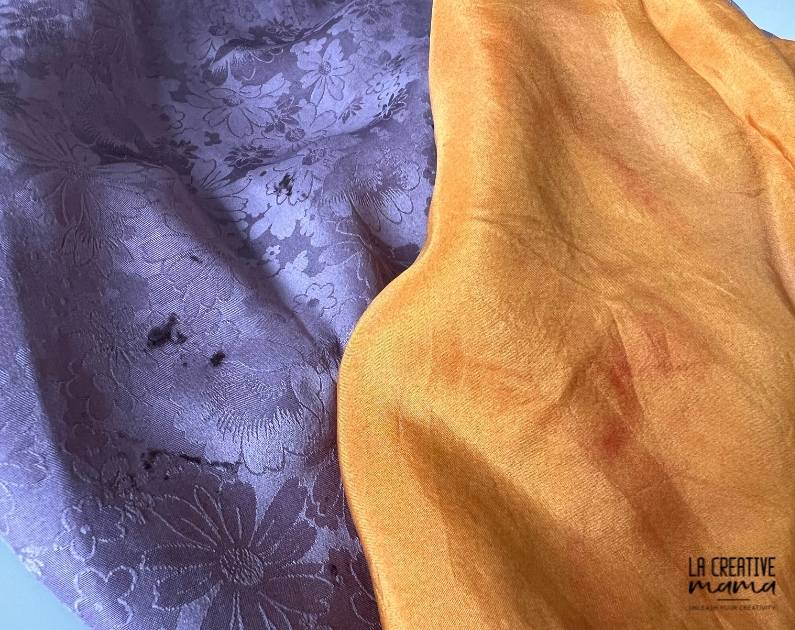 a purple fabric which has spots of dye extract on it. An orange fabric which has streaks on it. 