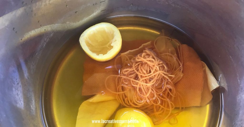 fabric and wool yarn inside a stainless steel pot