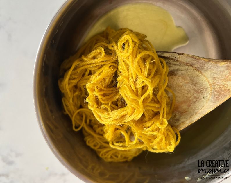 wet yarn which has been dyed using goldenrod flowers 