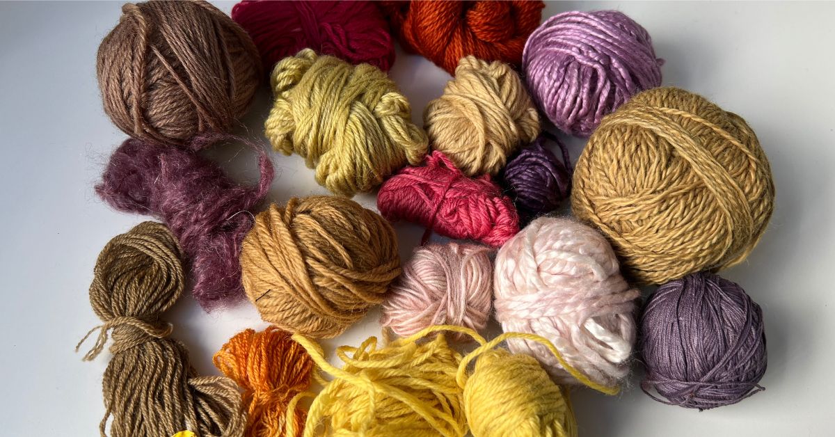 a variety of bright reds, pinks, yellows and purples on naturally dyed wool yarn using natural dyes