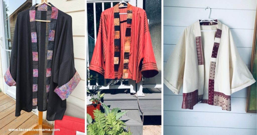 Three kimono jackets hanging side-by-side—black with floral trim, rust with patchwork trim, and cream with earth-toned patchwork hem.