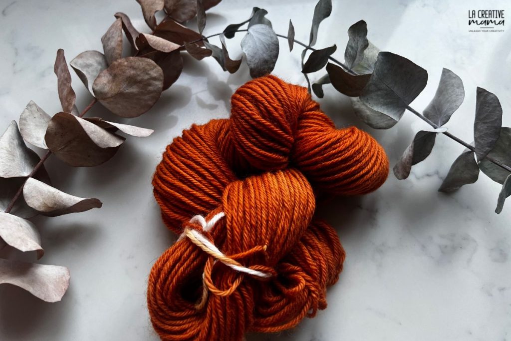 skein of wool dyed using eucalyptus cinerea is a bright orange color
