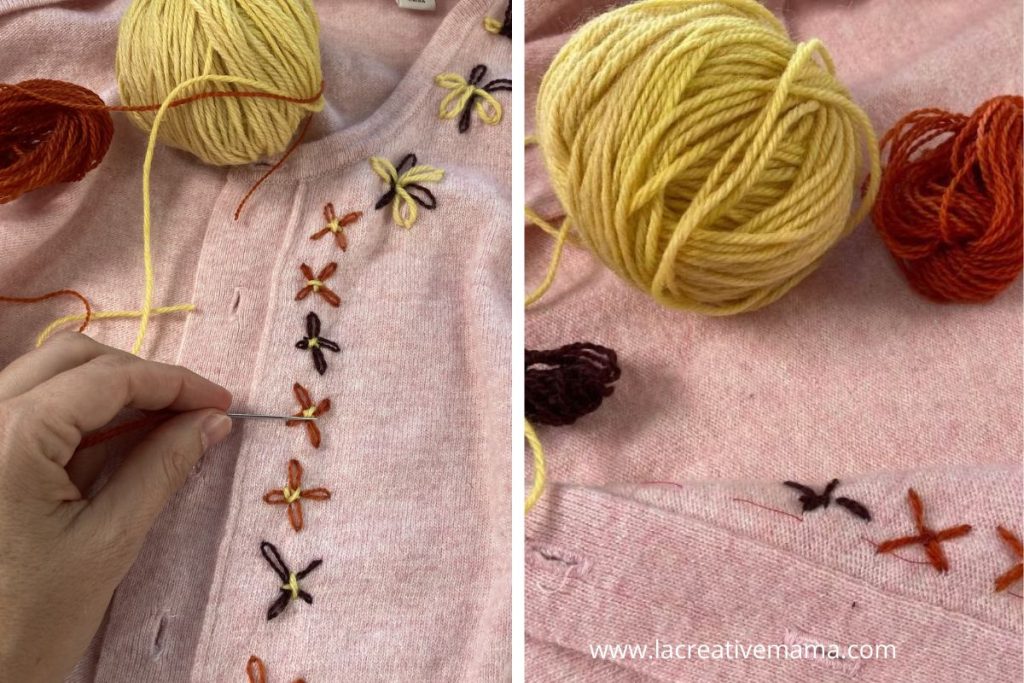 Embroidered flower stitches in naturally dyed yarn covering small holes on a pink knit cardigan